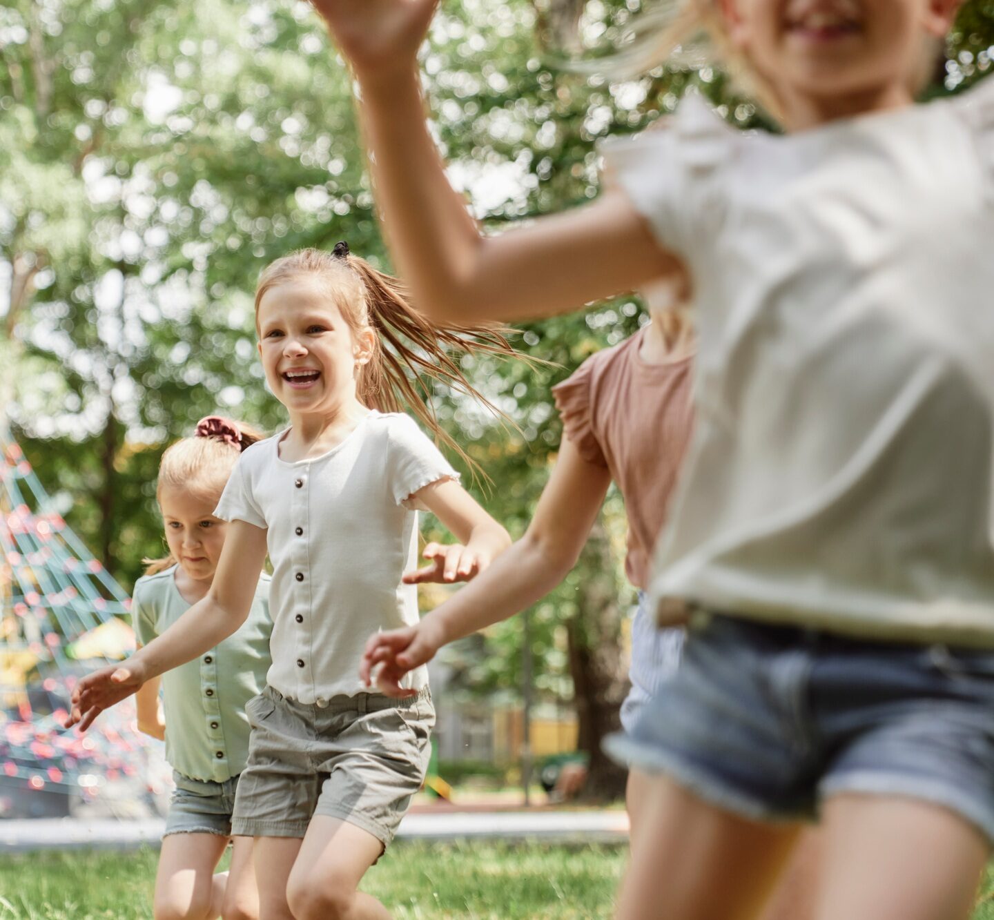 Group of kids playing at the playground in summer day