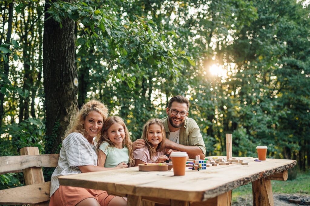 Portrait of a happy family spending day in nature and playing games.